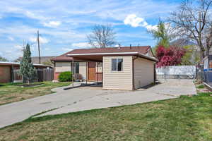 View of front of home featuring a patio area, a gate, and concrete driveway