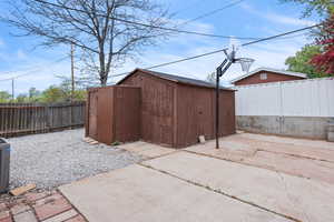 Fenced backyard with a storage shed