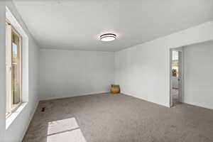 Empty room with plenty of natural light and light carpet