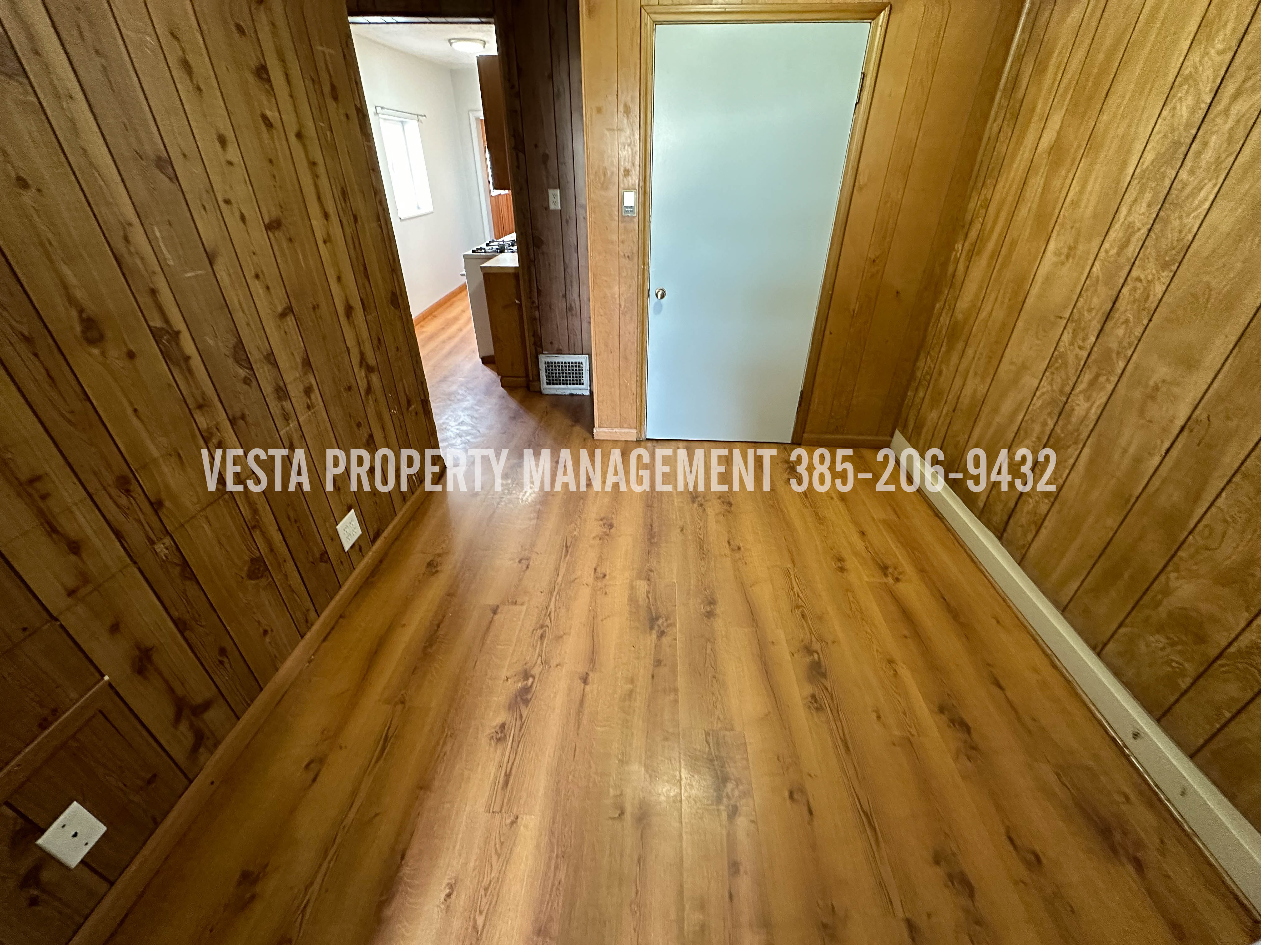 Spare room featuring hardwood / wood-style flooring and wooden walls