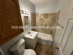 Full bathroom featuring vanity, shower / bathtub combination, and light tile patterned flooring