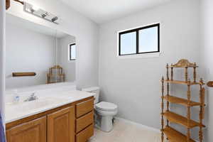 Half bath featuring vanity and light flooring