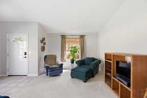 Living area featuring light carpet and light tile patterned floors