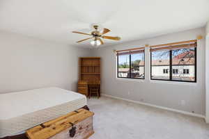 Bedroom featuring light carpet and ceiling fan