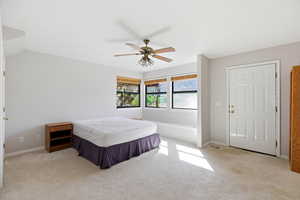 Bedroom featuring light carpet and a ceiling fan