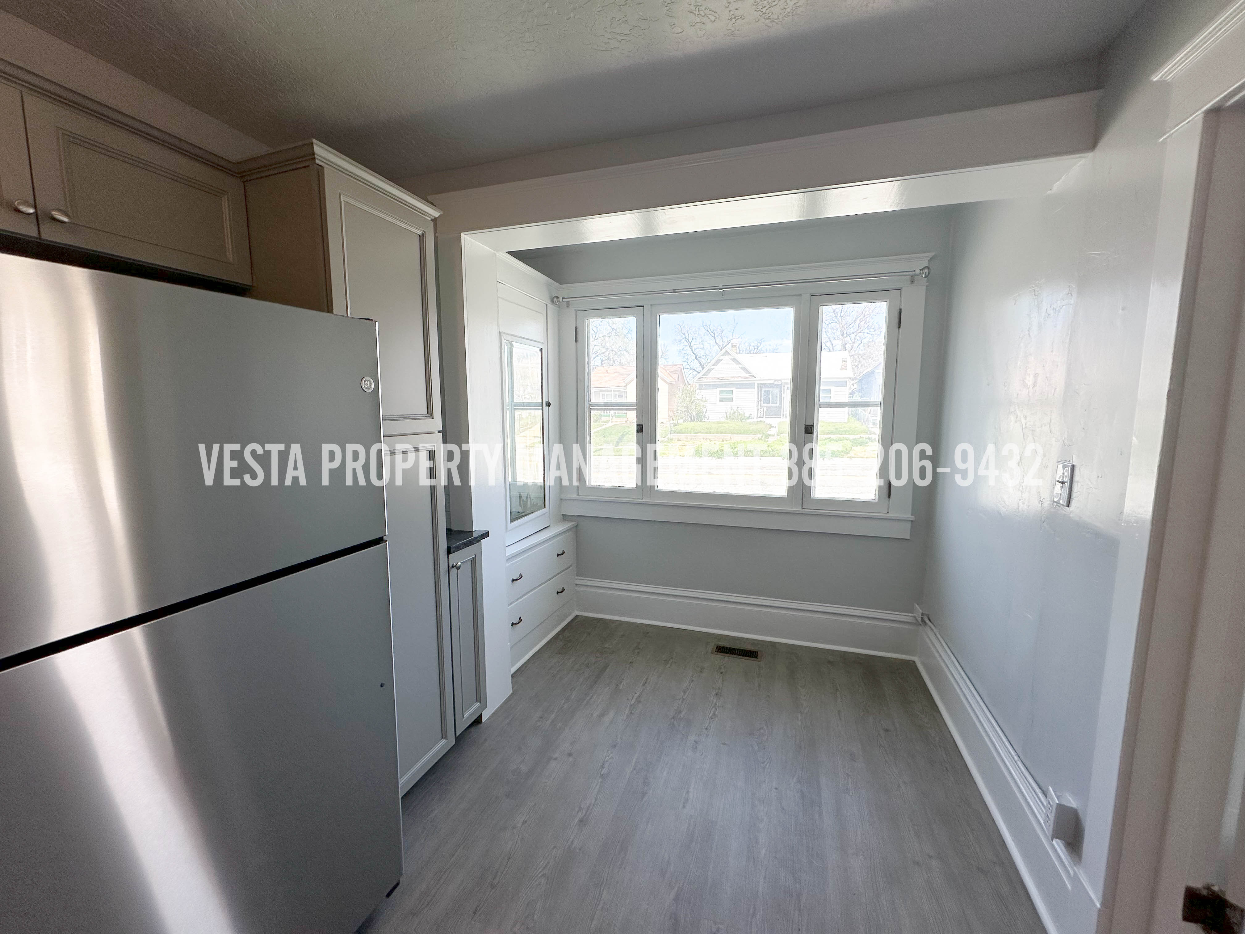 Kitchen with freestanding refrigerator and light wood-type flooring