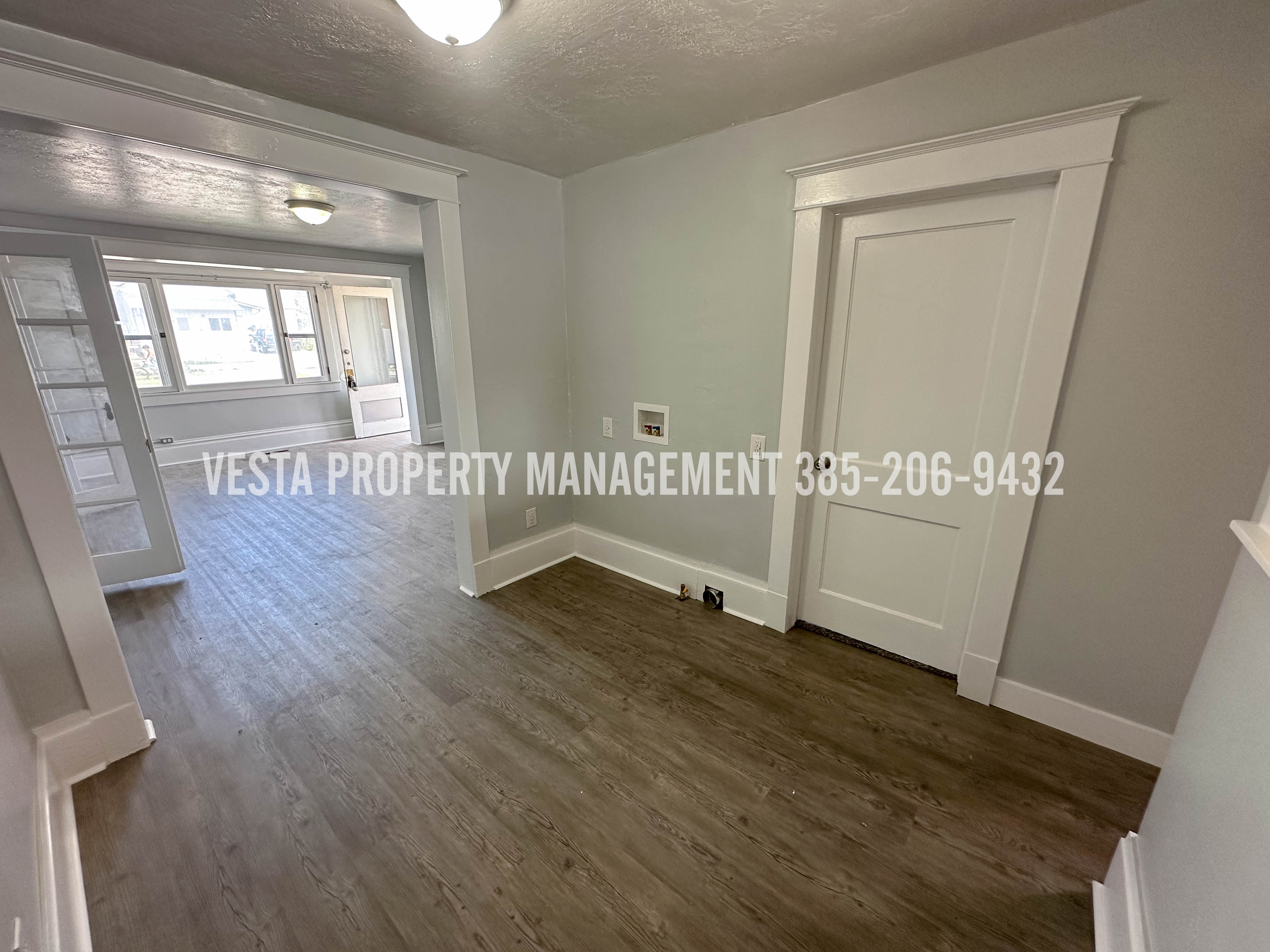 Unfurnished room featuring dark wood-style floors and a textured ceiling