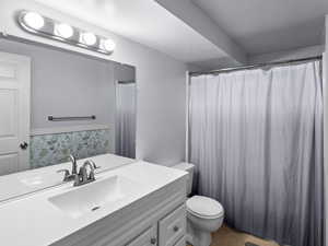 Bathroom with vanity and curtained shower