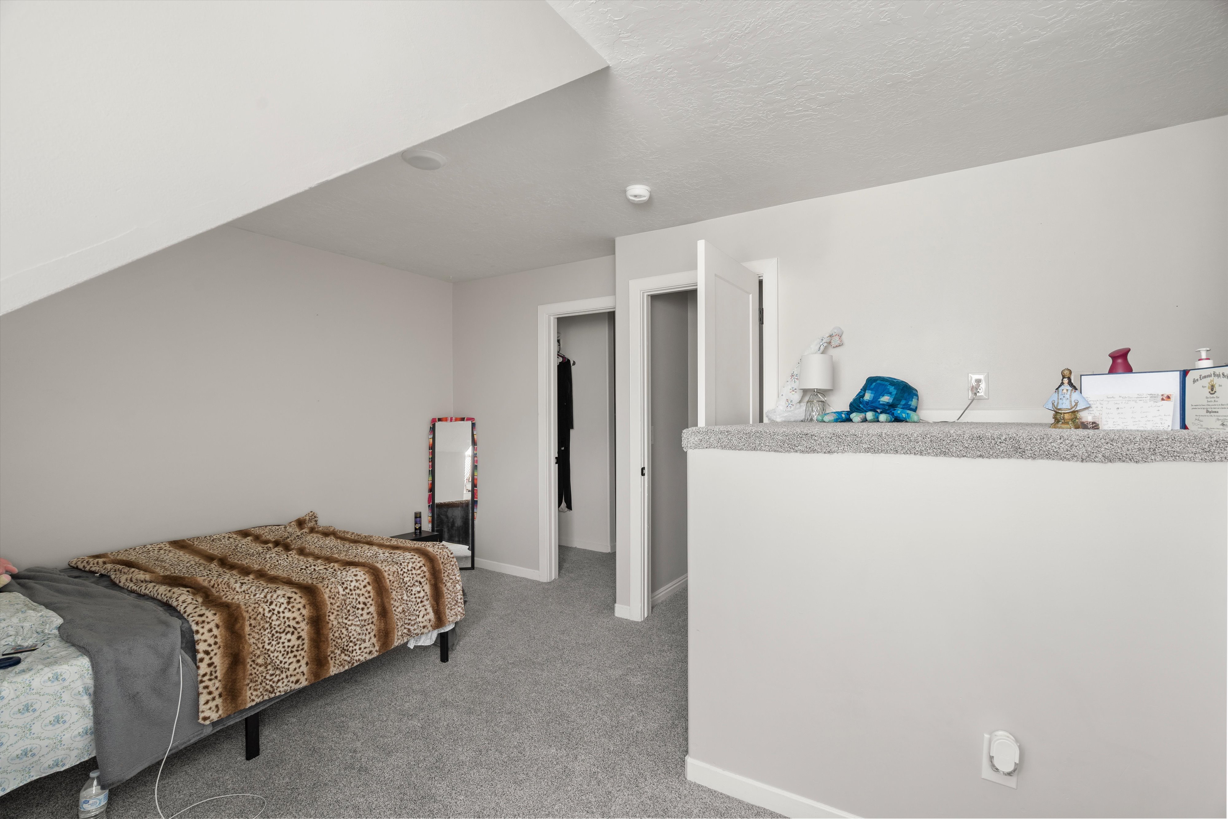 Bedroom featuring light colored carpet and baseboards
