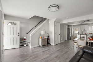 Living area with stairs and light wood-type flooring
