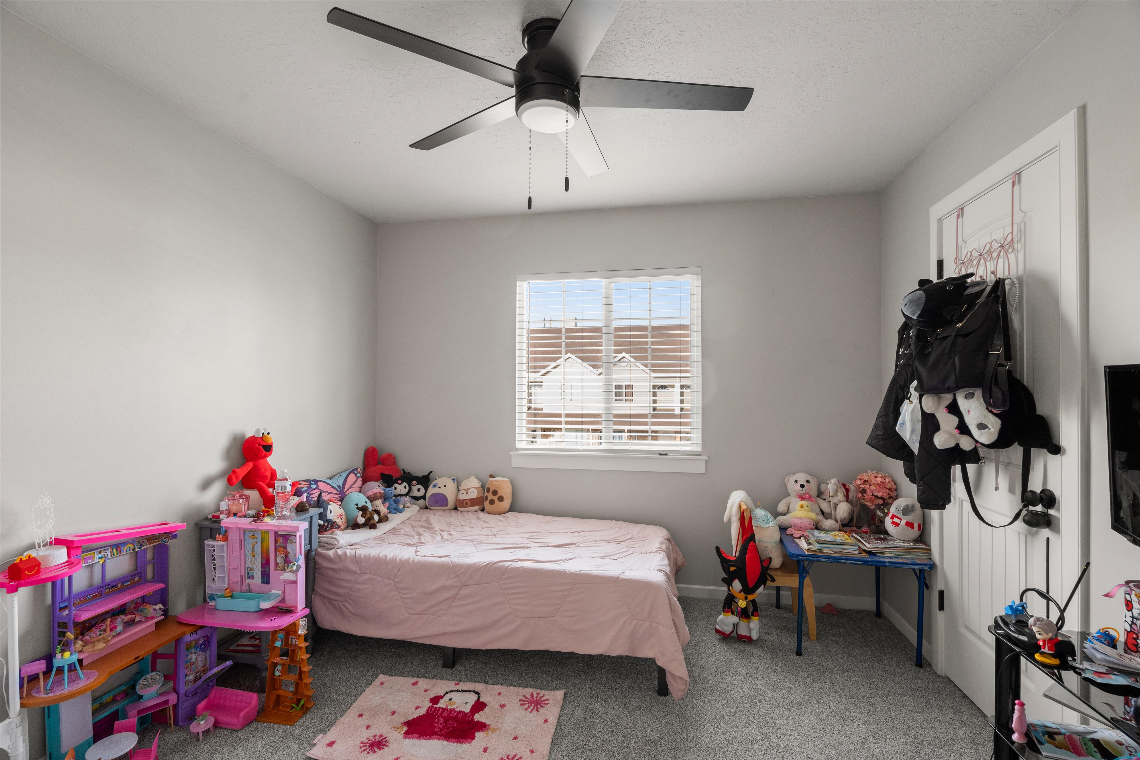 Bedroom with carpet floors and a ceiling fan