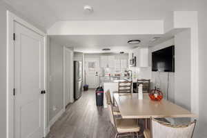 Dining space with light wood-style flooring and baseboards