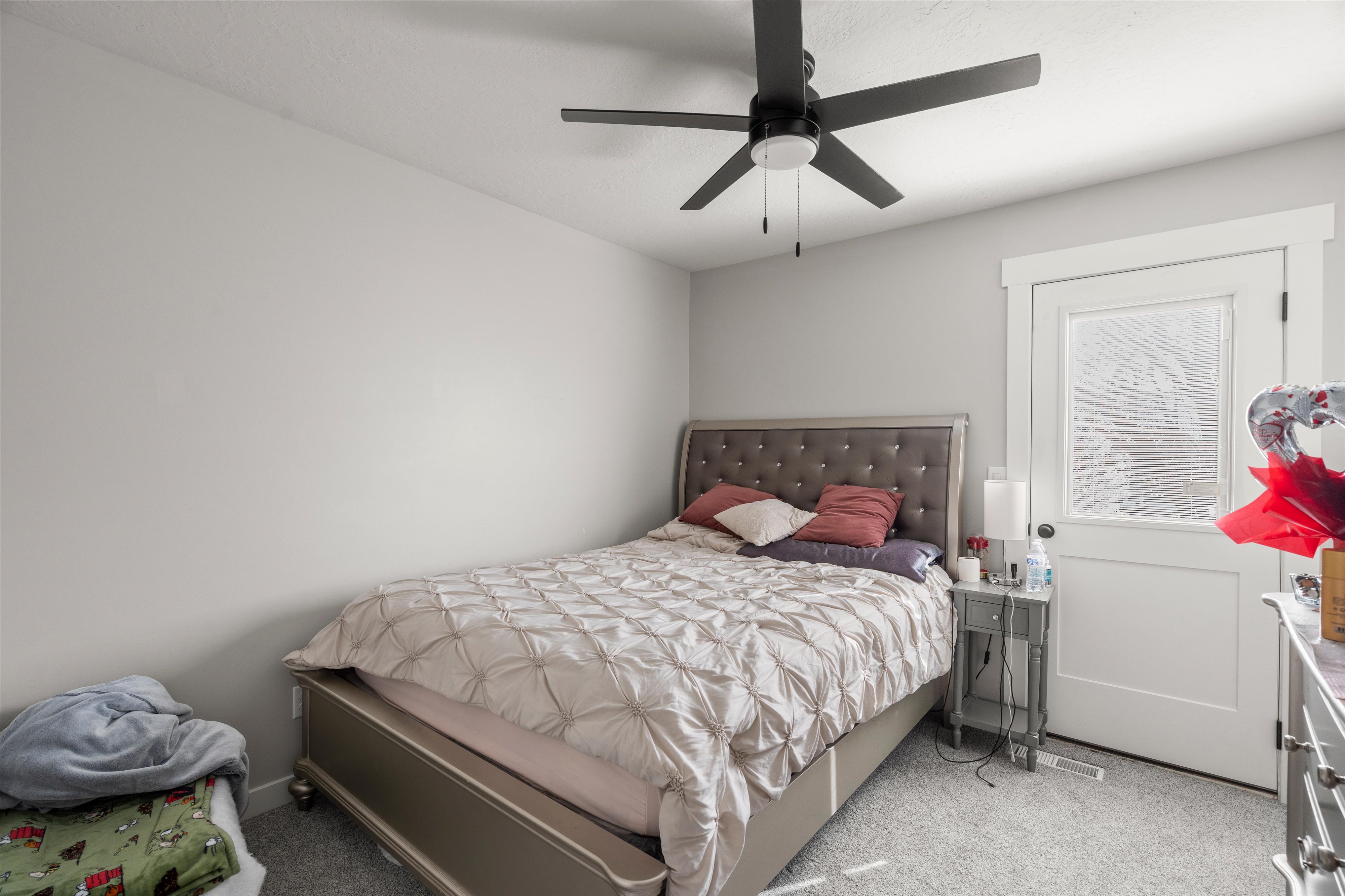 Bedroom with light carpet and ceiling fan