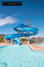 Community pool featuring a water slide and a mountain view