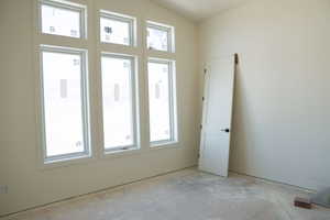 Spare room with vaulted ceiling