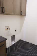 Laundry area featuring cabinet space, washer hookup, and electric dryer hookup