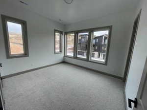 Empty room with carpet flooring and baseboards