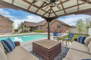 View of swimming pool featuring an outdoor living space and patio surround