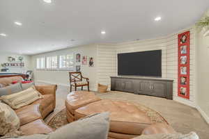 Living room featuring light colored carpet and recessed lighting