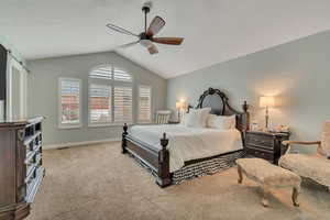 Carpeted bedroom featuring a ceiling fan, a barn door, and a textured ceiling