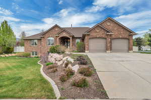 View of front facade featuring concrete driveway, a garage, a front yard, brick siding, and a shingled roof