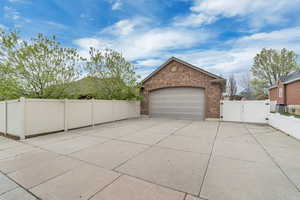Garage with a gate and concrete driveway