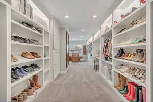 Walk in closet with light carpet