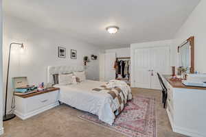 Bedroom with light colored carpet