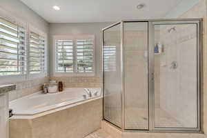 Full bath featuring a stall shower, a bath, recessed lighting, and vanity