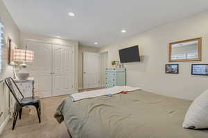 Bedroom with a closet, carpet flooring, and recessed lighting