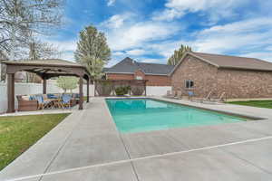 View of swimming pool featuring patio surround, an outdoor living space, a gazebo, a diving board, and a fenced backyard
