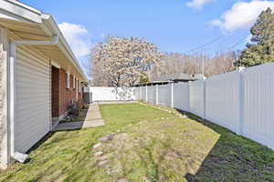 View of fully fenced backyard, private to each duplex with a fence between them.  Sprinkler system disarmed to conserve water.