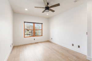 Unfurnished room featuring light wood finished floors, a ceiling fan, recessed lighting, and a smoke detector