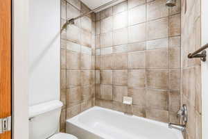 Full bathroom featuring toilet and tub / shower combination