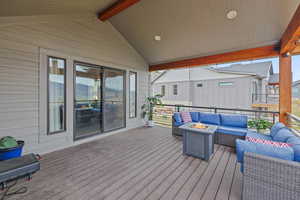 Deck featuring an outdoor living space with a fire pit