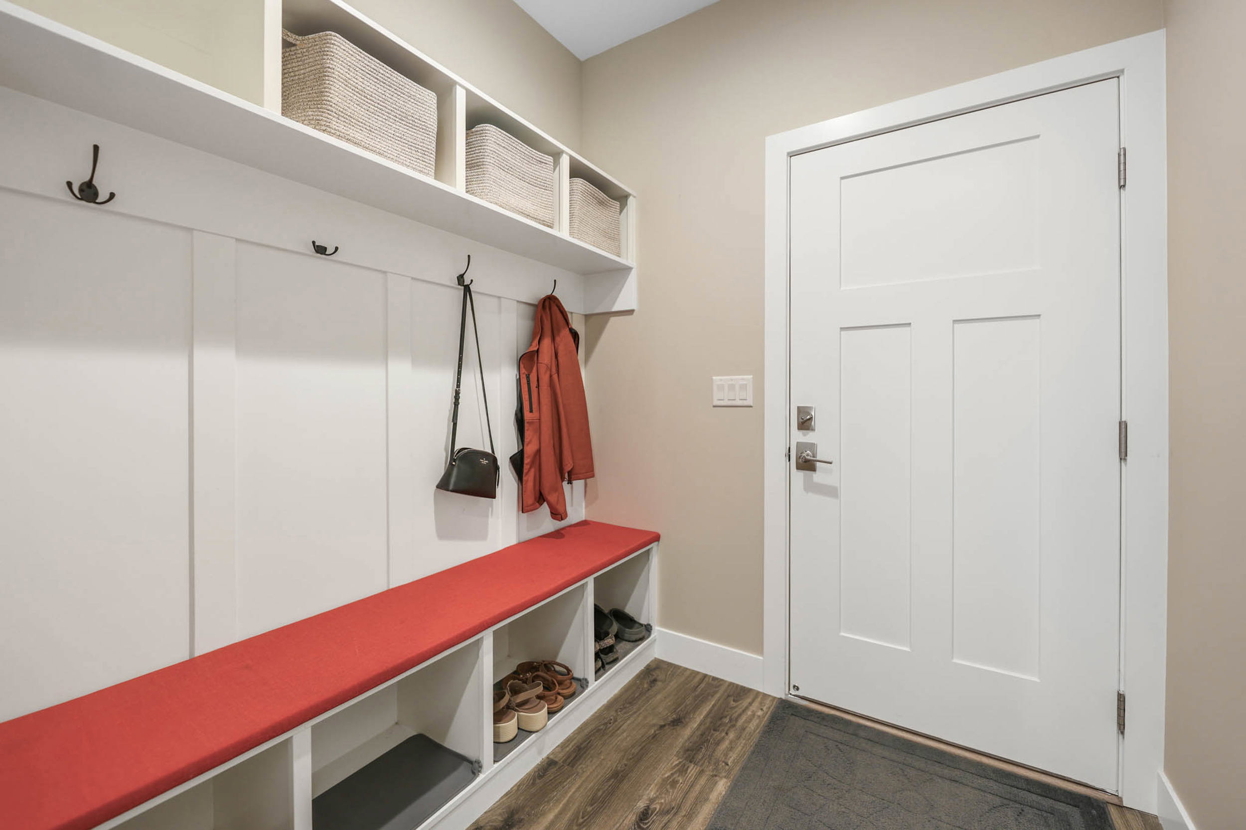 Mudroom featuring dark wood finished floors and baseboards