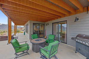 View of patio / terrace with a fire pit, a mountain view, and area for grilling