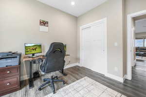 Office area featuring wood finished floors and recessed lighting