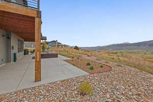 View of yard with a patio, a hot tub, and a mountain view
