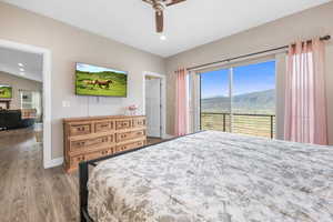 Bedroom featuring access to exterior, dark wood-style flooring, recessed lighting, and ceiling fan