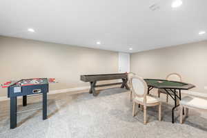 Recreation room featuring light colored carpet and recessed lighting
