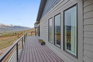 Deck with a mountain view and a view of countryside