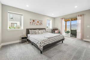 Bedroom featuring light carpet, access to outside, a mountain view, and recessed lighting