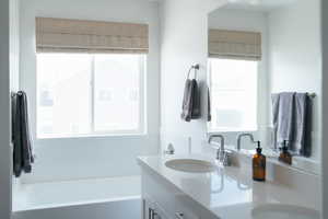 Bathroom with double vanity and a bath