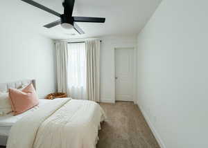 Bedroom featuring ceiling fan and carpet floors