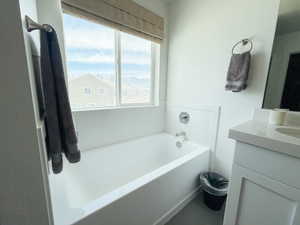 Bathroom with a bath and vanity
