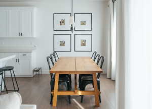 Dining room featuring light wood-style flooring and baseboards
