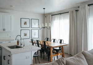 Dining space featuring suspended lighting and wood finished floors