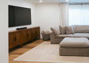 Living room featuring light wood-style floors and recessed lighting