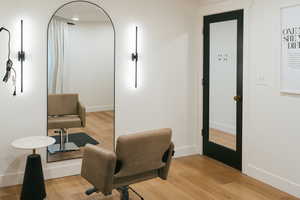 Sitting room featuring light wood-type flooring and baseboards